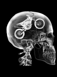 a black and white photo of a skeleton with a motorcycle on it's head