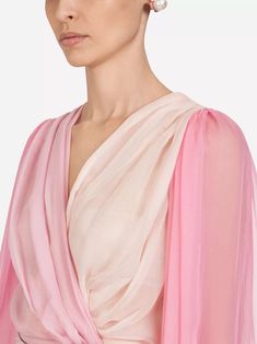 This Two-Tone Chiffon Blouse from Dolce & Gabbana is made of lightweight silk, providing a breathable, comfortable fit. Its crossed closure creates sensual finish, while delicate degradé pink nuances add romantic touch. Enjoy effortless style all day long with sophisticated piece. Fitted Silk Pre-draped Blouse, Feminine Silk Chiffon Blouse For Summer, Feminine Silk Chiffon Blouse For Spring, Evening V-neck Chiffon Blouse, Elegant Pink Silk Blouse, Chiffon V-neck Tops For Evening, Sheer Silk V-neck Top, Elegant Blouse With Draped Sleeves In Georgette, Elegant Georgette Blouse With Draped Sleeves