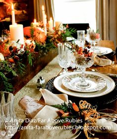 a dining room table set for christmas dinner with candles and napkins on the plates