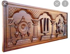 an intricately carved wooden panel with carvings on it