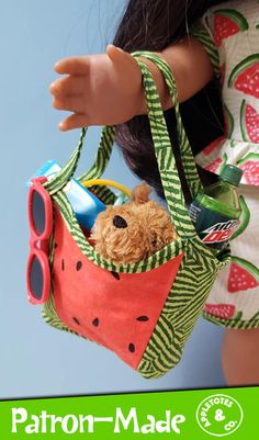 a doll is holding a purse made out of fabric and watermelon print material