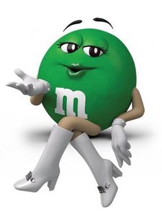 a green ball sitting on the ground with its hands out and eyes wide open, while pointing