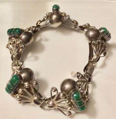 This beautiful Mexican sterling silver stamped hinged cuff bangle bracelet boasts green carved onyx panels and a beautiful open work filigree type of design. The bracelet dates to the 1940s-60s, and it would fit a medium to large lady's wrist. It's approximately 8 inches long and about an inch wide at its widest points. In good used vintage condition, the bracelet is free from damage or repair and shows expected patina wear and tarnish. It weighs a hefty 40 grams. Please make sure to view all th Green Bangle For Collectible Jewelry, Green Bangle Jewelry Collectible, Green Bangle Collectible Jewelry, Vintage Green Bangle Jewelry, Green Art Deco Bracelets As A Gift, Green Art Deco Bracelets For Gift, Green Art Deco Bracelets As Gift, Green Art Deco Bracelet As Gift, Vintage Green Sterling Silver Bracelets