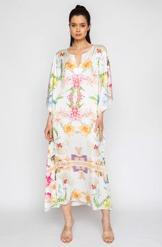 Bring out your inner flower in the Botanica Long Caftan. This gorgeous piece of apparel features delicate flowering patterns, giving you the freedom to show off your unique style. And the airy fabric won’t weigh you down, meaning you can wear your beauty around the clock! Bloom into something special with the Botanica Long Caftan. Printed short caftan Can be worn loose or cinched at the waist Comes with a matching belt as an option for styling Lusciously soft poly-silk blend for ease of care Mac V-neck Floral Print Tunic For Beach Cover-up, Elegant Spring Kaftan For Beach Cover-up, Spring Floral Print V-neck Kaftan, Bohemian V-neck Tunic With Floral Print, Spring Beachwear Maxi Tunic, Spring Bohemian Kaftan With Kimono Sleeves, Spring Maxi Length Beachwear Tunic, Bohemian Maxi Kaftan With Floral Print, Spring Maxi Length Tunic For Beachwear