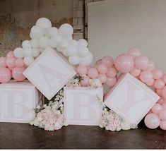 balloons and flowers are arranged in front of the baby blocks