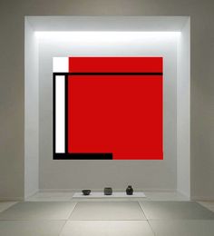 an abstract painting in a white room with red and black squares on the wall behind it