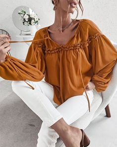 The EMES SHOP blouse is detailed with cute ruffle details. Features a tie neck. drop shoulder. solid color. and flowy fit. Pair it with palazzo pants and sunnies for a fantastic look.MATERIAL:100%Soft Poly MEASUREMENTS:Product Length 24"-26"in Small | Bust & Hem Width : 39"-41"in Medium| Bust & Hem Width : 41"-43"in Large| Bust & Hem Width : 43"-45"in X Large| Bust & Hem Width : 45"-47"in MEASUREMENTS:Product Length 60"-65"cm Small | Bust & Hem Width : 99"-104"cm Medium| Bust & Hem Width :104"-1 Versatile Spring Blouse In Solid Color, Versatile Blouse For Spring, Chic Relaxed Fit Solid Color Blouse, Solid Color Summer Blouse For Vacation, Fall Tops With Tie Sleeves For Brunch, Fall Brunch Tops With Tie Sleeves, Chic Solid Color Blouse For Spring, Chic Solid Color Blouse For Vacation, Trendy Ruffle Sleeve Blouse For Fall