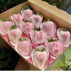 a box filled with pink chocolate covered strawberries