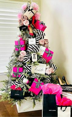 a christmas tree decorated with pink and black ribbons