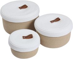 three white rope storage baskets with brown leather handles on each side and one has a wooden handle in the middle