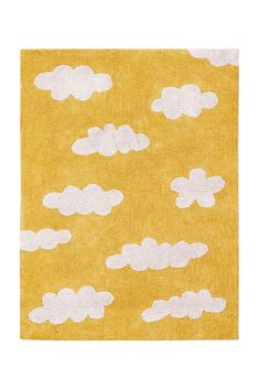 a yellow rug with white clouds on it