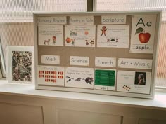 a bulletin board sitting on top of a window sill with pictures and words attached to it