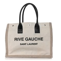 This is an authentic SAINT LAURENT Linen Calfskin Small Rive Gauche Tote in Greggio and Natural.This stylish tote is crafted of off-white linen with Rive Gauche, Saint Laurent printed across the front. The tote features tall black leather handles and opens toa matching canvas interior with a hanging zipper pocket. Saint Laurent Rive Gauche Tote, Rive Gauche, Leather Handles, White Linen, Leather Handle, Zipper Pocket, Calf Skin, Saint Laurent, Black Leather