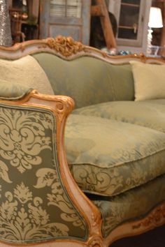 an ornate couch and chair in a store