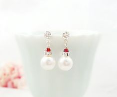 "These crystal drop earrings are made with 8mm Swarovski® White pearls, clear crystal rondelles and tiny 3mm ruby red crystals, which dangle from crystal silver stud earrings. These small 3/4\" long sparkly silver wedding earrings make a lovely bridesmaid or bridal party gift. If you would like these earrings made with a different color crystal and/or pearl, just message us. Thank you for looking. - Shop Gemsicles, an Etsy boutique with hundreds of sparkly items for weddings, gifts and just beca Red Pearl Drop Bridal Earrings Gift, Red Pearl Drop Earrings For Wedding, Red Pearl Earrings For Wedding, Bridal Proposal, Weddings Gifts, Etsy Boutique, Ivory Pearl, Crystal Drop Earrings, Bridal Party Gifts