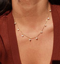 This lightweight and delicate piece features dangle pearl charms that make it perfect for both everyday wear and special occasions. The adjustable length ensures a comfortable fit, while the PVD plated finish ensures that your necklace stays water safe and tarnish resistant. Create a chic and minimal pearl look by layering the Calypso Necklace with your favorite pieces.  *Single Necklace * Faux Pearls * 15.5" + 2" extender (to make adjustable) ►PVD EXTRA DURABILITY: Our jewelry uses a special co Dainty Pearl Charm Necklace For Everyday, Elegant Charm Necklaces With Tiny Beads, Elegant Tiny Beads Charm Necklaces As Gifts, Elegant Charm Necklaces With Tiny Beads For Gifts, Dainty Pearl Charm Necklace With Clavicle Chain, Elegant Charm Necklace With Tiny Beads For Gift, Delicate Pearl Pendant Charm Necklace, Dainty Adjustable Pearl Charm Necklaces, Adjustable Dainty Pearl Charm Necklaces