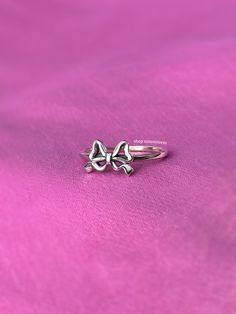 A stunning coquette style ring featuring a darling ribbon bow tie. - Water resistant - 925 sterling silver - Will not rust or tarnish - Select desired size at checkout Silver Midi Rings For Gift, Adjustable Sterling Silver Midi Rings As Gift, Adjustable White Gold Butterfly Ring As Gift, Dainty Silver Butterfly Ring For Anniversary, Celestial Silver Midi Rings For Anniversary, Adjustable Silver Midi Rings As Gifts, Silver Dainty Butterfly Ring As Promise Ring, Dainty Silver Midi Rings For Gift, Dainty Sterling Silver Butterfly Ring For Anniversary