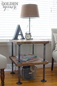 a small table with a lamp and some books on it in front of a window