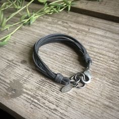 "-This unisex bracelet is made from soft deerskin leather. 7 strands of leather wrap around the wrist with an adjustable antique-silver color lobster clasp closure. So comfortable you won't want to take it off. -Size is adjustable from 7.25\" - 8.25\". Fits small to medium wrists. Larger sizes available by request. -Deerskin leather is ethically and sustainably sourced in the USA. -10 colors offered. Available in antique-brass or antique-silver color clasp. -Designed and handmade in South Pasade Adjustable Gunmetal Bracelet For Everyday, Adjustable Silver Grunge Bracelet, Creepy Earrings, Exotic Necklace, Wide Bracelet, Unisex Bracelets, Deer Skin, Bracelet For Men, Leather Wraps