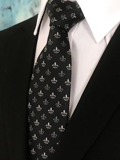 "Perfect for a black-tie wedding. This black tie with Fleur De Lis design is a classic must have tie. Available as an extra-long necktie. Handmade from 100% silk, this special collection features a .75\" Eds Neckties logo at the bottom right front corner of every tie and a larger logo located on the tipping (Back of the tie). The label features the collection name (Nathaniel Alexandria) Named after my son Nathaniel and my daughter Alexandria. Expertly hand-made from 100% silk you can select your Creative Black Tie, Black Tie Dress Code, Wedding Black Tie, Man Suits, Purple Gothic, Make A Tie, White Goth, Blue Necktie, Floral Necktie