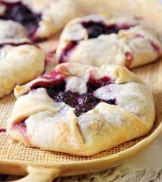 small berry pies on a wooden tray