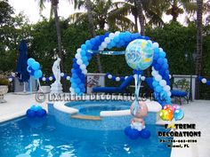 a pool with balloons and decorations around it