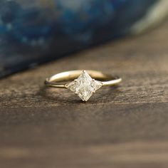 a diamond ring sitting on top of a wooden table