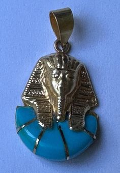 Vintage Egyptian Pendant King TUTANKHAMEN 18K yellow Gold & Turquoise gemstone made in Cairo.  Stamped with Egyptian Gold 18k Mark.  Item has seen minimal use.  Pendant only no chain.  Some scratches on the back of pendant    Length: 1.0"  Width:  0.7" Egyptian Pendant, Egyptian Gold, King Tut, Turquoise Gemstone, Cairo, Light Purple, Jewelry Necklace Pendant, Jewelry Necklaces, Accessory Gift