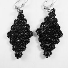 "This pair of diamond shaped lacy black beaded dangle earrings were bead woven with tiny black glass beads and faceted glass beads. The earrings hang from tarnish resistant stainless steel lever back ear wires. Total length of earrings measure: 3.00\" inches ( 7.62 cm ) from ear holes to bottom of beads. The widest part of the earring is 1.00\" inch (2.54 cm ) across.   https://www.etsy.com/shop/FMGuyDesigns" Toms River Nj, Beaded Dangle Earrings, Diamond Shaped, Faceted Glass, Beaded Dangles, Bead Weaving, Black Glass, Black Beads, Ear Wires