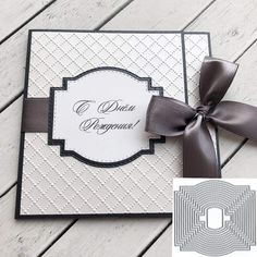 a close up of a card with a bow and ribbon on the top of it