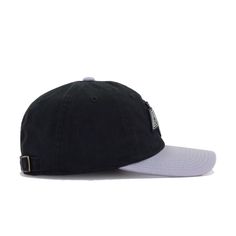 a black and white hat with the word's on it, sitting against a white background