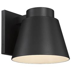 a black wall light with a white shade