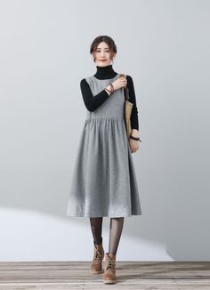 "FEATURES * 25% wool, other fiber,nylon * Polyester lining * Two side seam pockets * Sleeveless wool dress * A-Line wool dress * Casual wool dress * Perfect for winter, autumn * Dry clean * Black blouse is not sale items * Size XS-Sample is ready to ship, Only 1 available, don't accept refund, exchange * The model is 170 cm (5′ 7″) tall with a 80 cm (31.5\") bust, 66 cm (26\") waist. She is wearing the wool dress in size XS. ★★ Get your size in Size Chart with your body measurement https://www.etsy.com/listing/794055682 ★★ Warmly Note: 1 ) : Loose hips design will show different Upper body effect when People of different sizes wear it. Maybe oversized on your hips part, maybe Close fitting effect. if you are not satisfied with the effect, please contact us, you can make a returns back. 2 ) Sleeveless Dresses With Pockets For Fall, Chic Sleeveless Winter Dress, Gray Knee-length Winter Dress, Casual Sleeveless Dress For Fall Workwear, Casual Sleeveless Dress For Work In Fall, Winter Midi Dress With Pockets, Fall Midi Length Sleeveless Dress For Work, Sleeveless Midi Dress For Workwear In Fall, Sleeveless Gray Dress For Winter