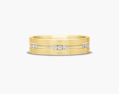 a yellow gold wedding band with three diamonds