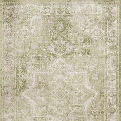 an antique rug with green and white colors