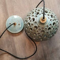 an old teapot with a string attached to it sitting on the floor next to another one