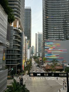 an empty city street with tall buildings in the background