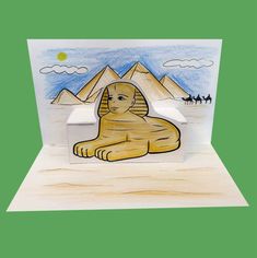 a card with an egyptian sphinx sitting on the ground and pyramids in the background