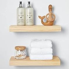 two wooden shelves with towels and soaps on them