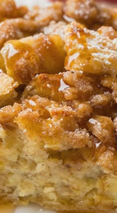 a close up of a piece of cake on a plate with fruit in the background