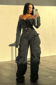 Off shoulder long sleeve denim jumpsuit featuring baggy leg details with cargo pockets Front button up closure We recommend wearing pasties, a strapless bra, or no bra with this garment Runs true to size 100 % Cotton Aaliyah is in size S Height: 5'0" Bust: 34" Waist: 24" Hips: 44" Black Corset Birthday Outfit, Birthday Outfits For October, Cargo Jumpsuit Outfit Black Women, Concert Fits Fall, Baddie Denim Outfits, Pants That Make You Look Thick, Fashionova Outfits Inspiration, Baddie Black Women Outfits, Instagram Outfit Ideas Baddie