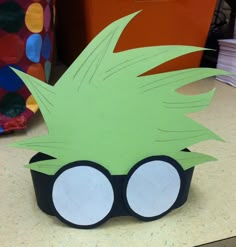 an image of a paper cupcake with glasses on the front and back side that is cut out to look like a cartoon character