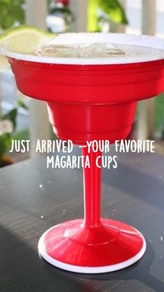 a red margarita sitting on top of a wooden table