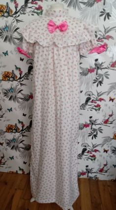 Stunning handmade nightgown, crafted from luxurious 100% Organic Cotton, soft and lightweight. Beautiful pink floral print. Retro vintage style with yoke and ruffle. Puffed sleeves. High Couture French seam which is  neat inside and soft on the skin. Lovely bow trims and ruffle. Measurements: Bust up to 46" Length 58" f Short Sleeve Floral Print Nightgown For Home, Floral Print Short Sleeve Dress For Pajama Party, Pink Floral Print Nightgown For Home, Feminine Ruffled Short Sleeve Sleepwear, Pink Floral Print Short Sleeve Nightgown, Pink Floral Print Nightgown With Short Sleeves, Pink Floral Print Short Sleeve Sleepwear, Pink Ruffled Sleepwear, Pink Fitted Ruffle Sleepwear