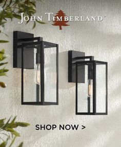 two outdoor lights on the side of a wall with text that reads, john timberland shop now