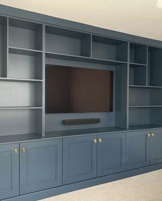 an entertainment center with built - in cabinets and a flat screen tv on the wall