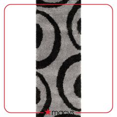 a gray and black rug with circles on it