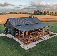 an aerial view of a house in the middle of a field