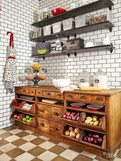 an old fashioned kitchen with lots of food on the counter and shelving above it