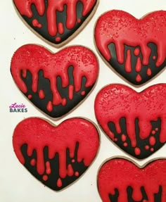 red and black decorated heart cookies in the shape of hearts with blood dripping down them